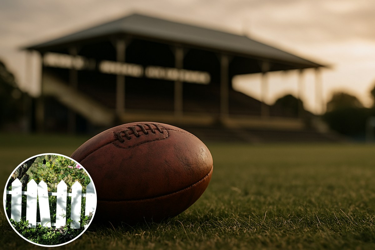 A worn football on an oval at golden hour before an old grandstand, with a picket fence inset.